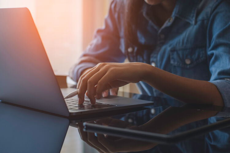 Woman Typing on a Laptop